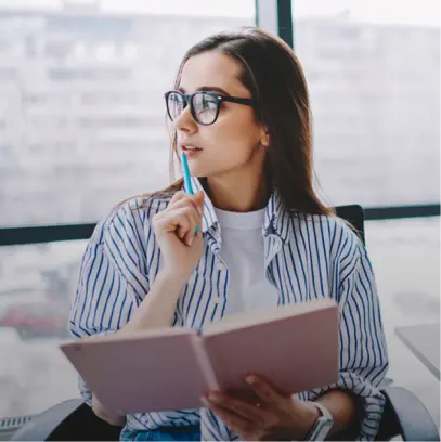 Woman thinking and writing